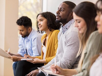 Group of diverse people listening to a speaker